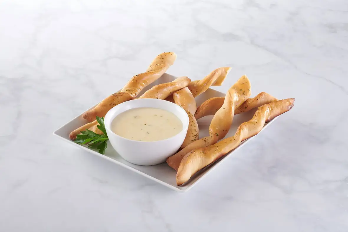 Pails, totes, drums, tubs, cups and dollops — soft breadstick twists with a creamy garlic dipping sauce