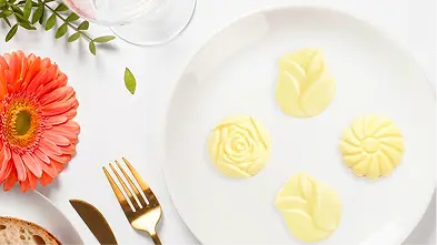 Single-serve butter pats plated in a restaurant