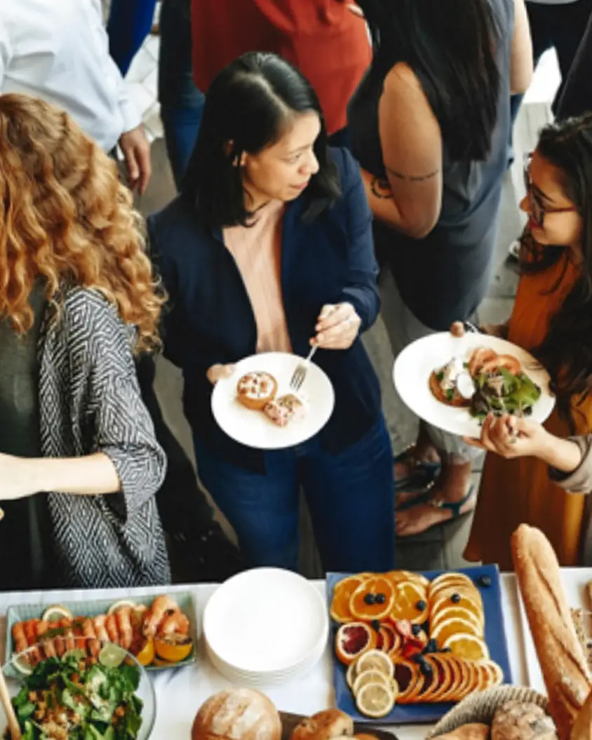 People sharing a meal with flavored butter dishes