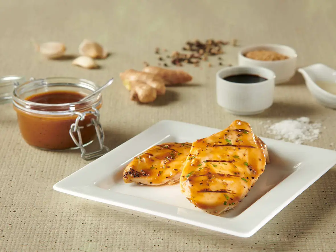 Grilled chicken breasts glazed with Butterball Farms custom sauce, served with a jar of glaze on the side