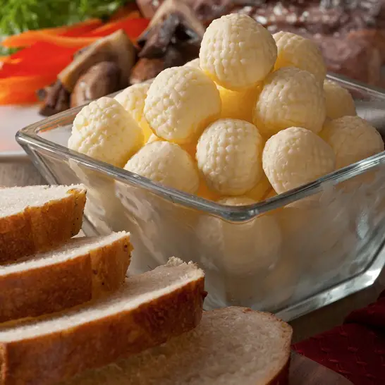 Single-serve shaped butter portions on a plate