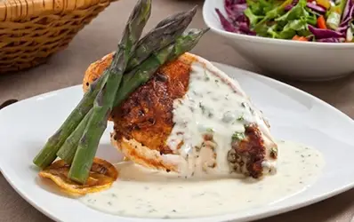 Specialty sauce poured over a prepared entree