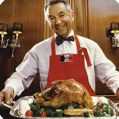 Leo Peters presenting a roast turkey in a Butterball apron