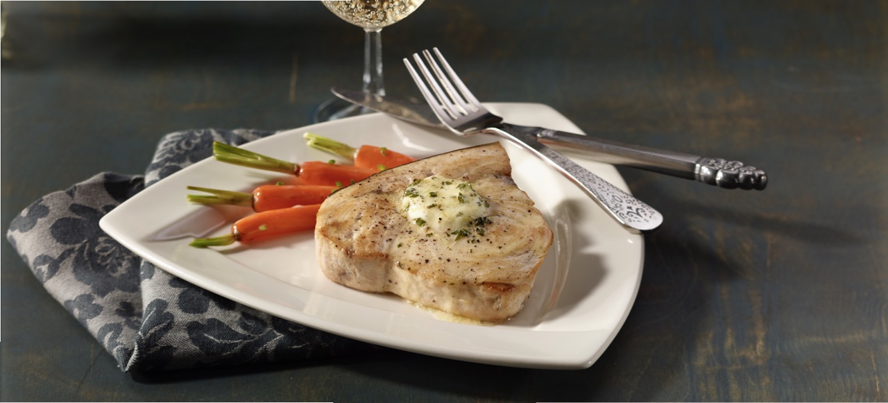 swordfish steak with flavored compound butter and carrots