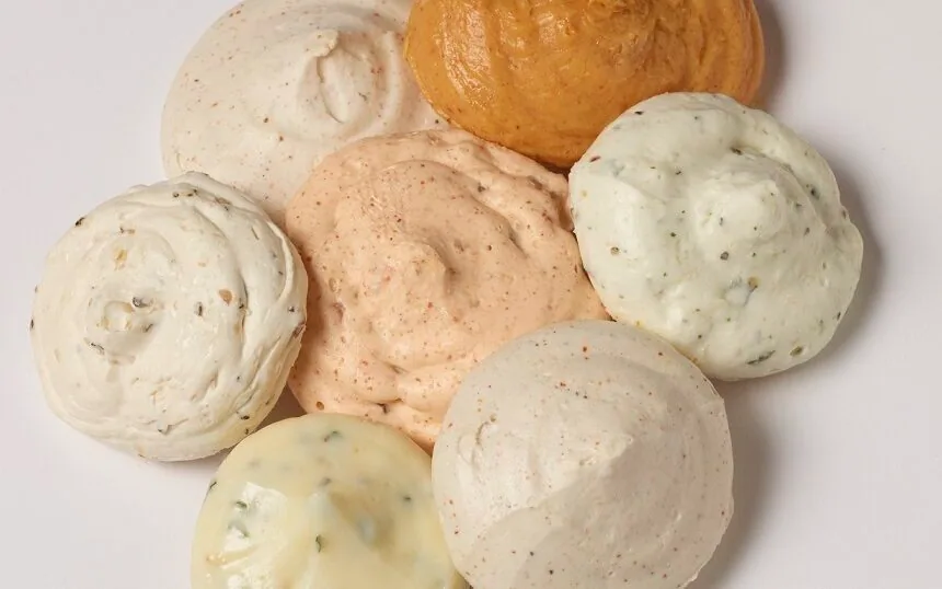 Assortment of seven Butterball Farms compound butter dollops in a circle