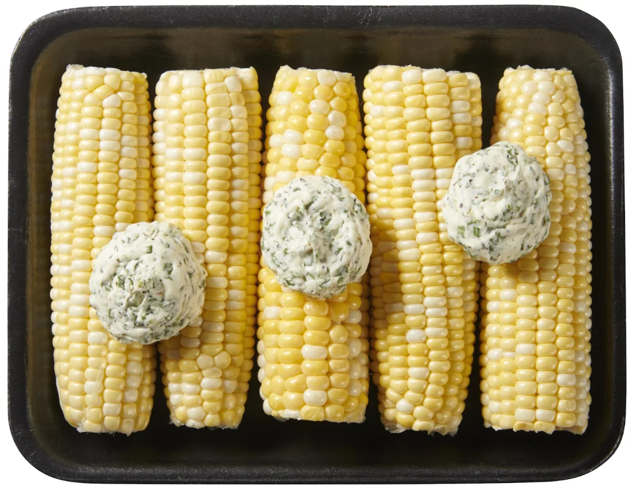 Five corn ears in a tray topped with herb butter dollops