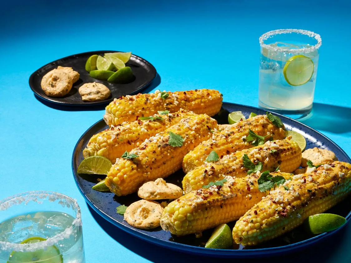 Grilled corn on the cob with chili-lime seasoning and margaritas