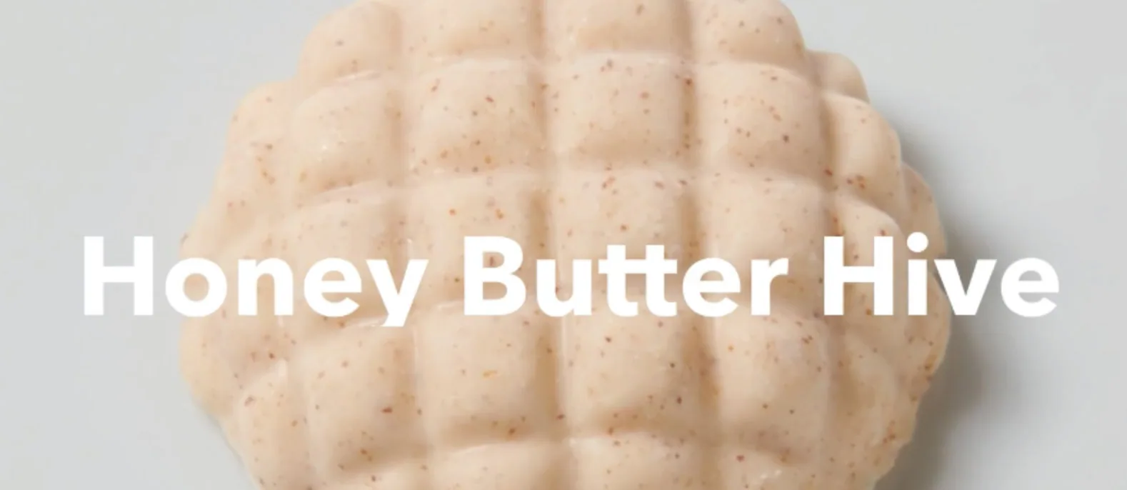 Honeycomb-shaped butter piece with Honey Butter Hive text