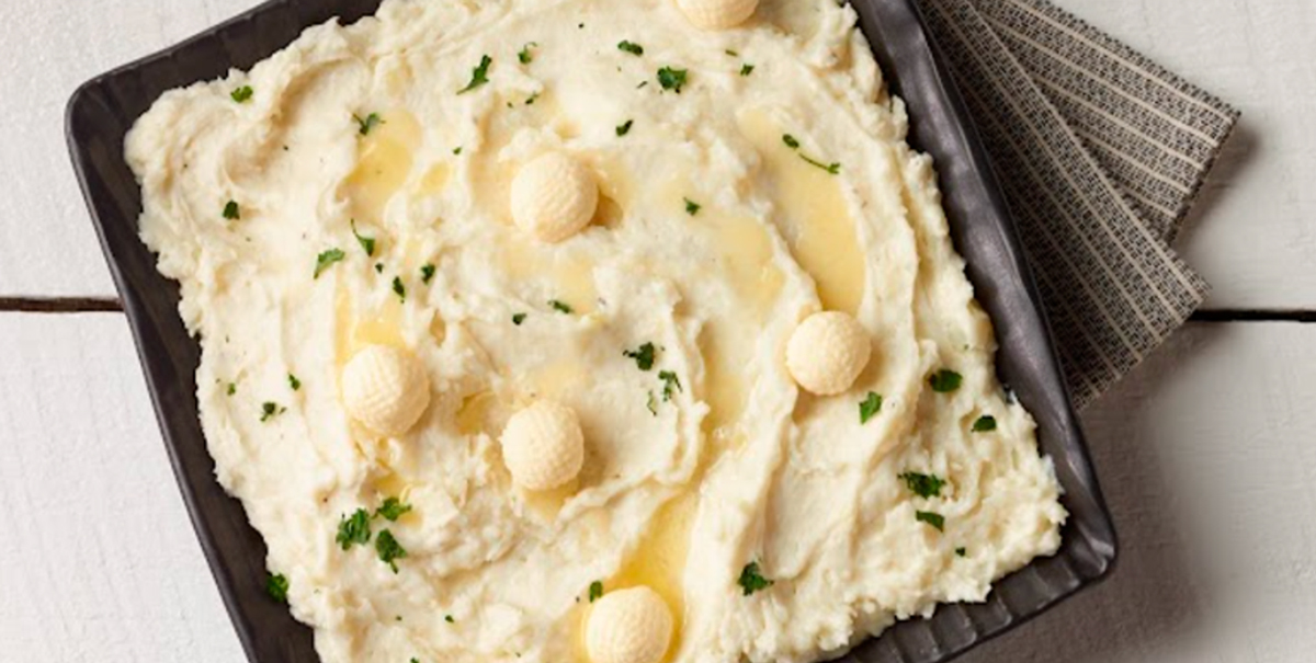 Mashed potato tray covered in herbs and butter dollops