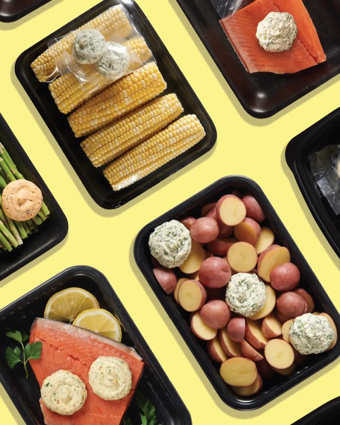 An overhead spread of Butterball Farms flavored butters with herbs, spices, cheese, bacon, fruit, and other ingredients on a blue background