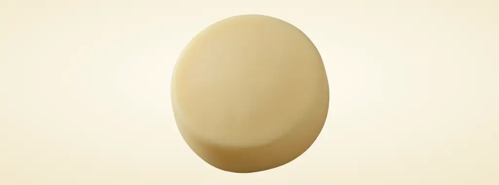 Single round butter ball on a cream background