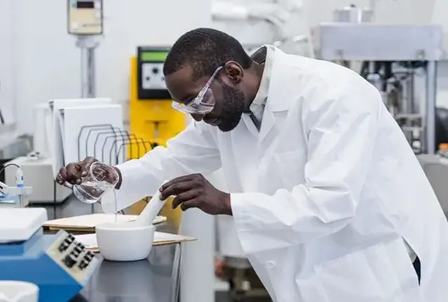 Butterball Farms lab technician pouring liquid into a mortar in the quality lab