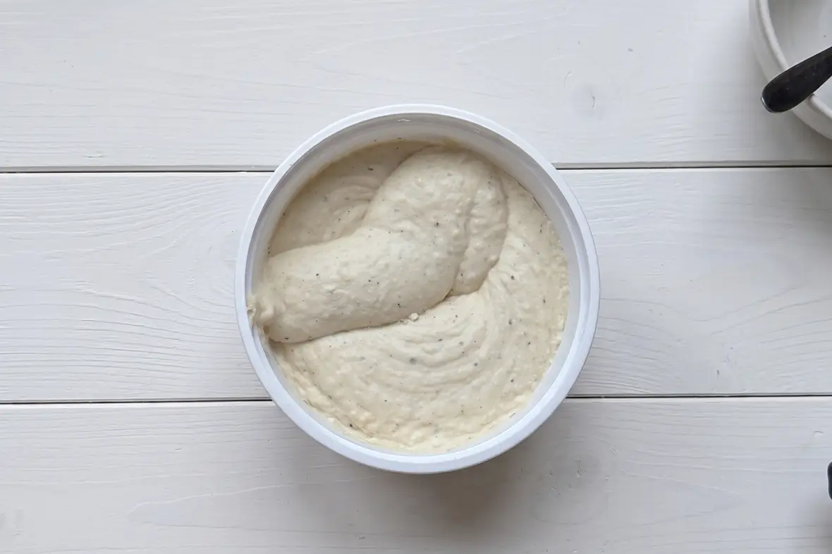 Aerated, fluffy and perfect for spreading — tubs of herb and spice whipped spreads beside fresh tomatoes