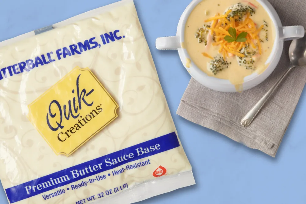 Quik-Creations premium butter sauce base pack beside a bowl of soup